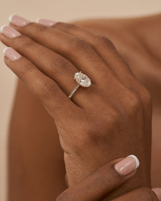 18 Karat Celine Oval Engagement Ring with Moissanite Center Stone and Diamond Accented Shank